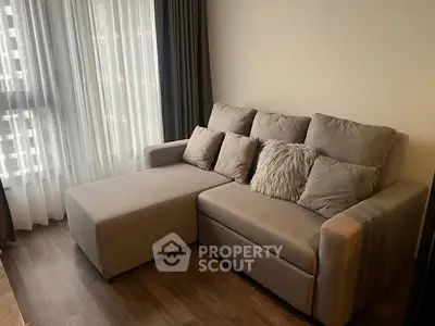 Cozy living room with stylish sofa and natural light from large window
