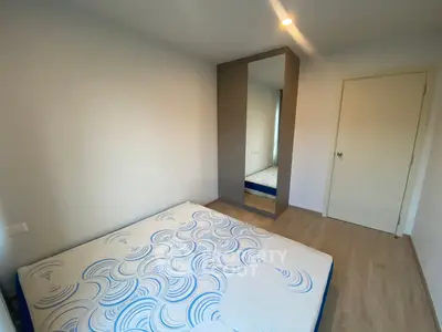 Modern bedroom with minimalist design and large mirror wardrobe