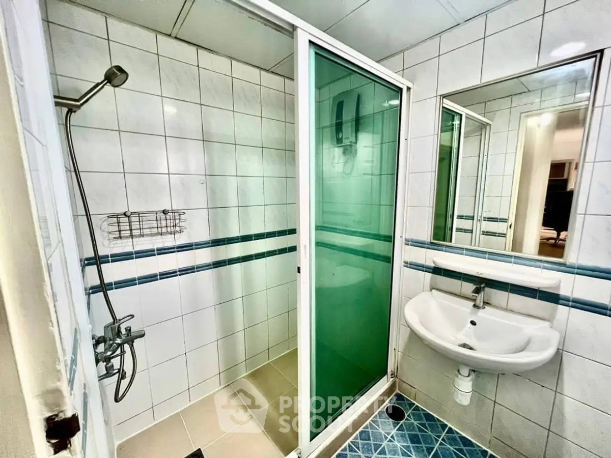Modern bathroom with shower and sleek white tiles
