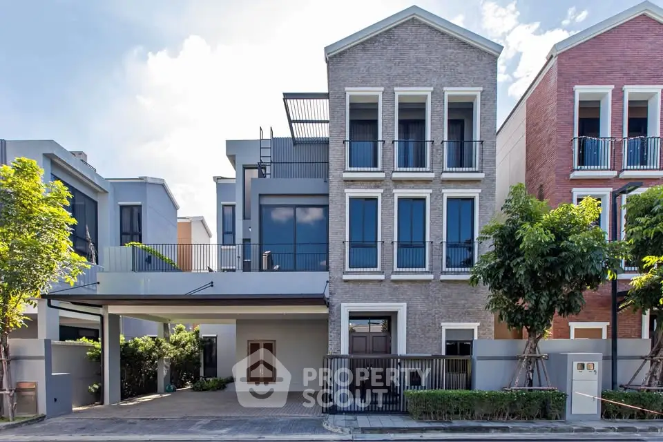 Modern townhouse exterior with sleek design and spacious balcony