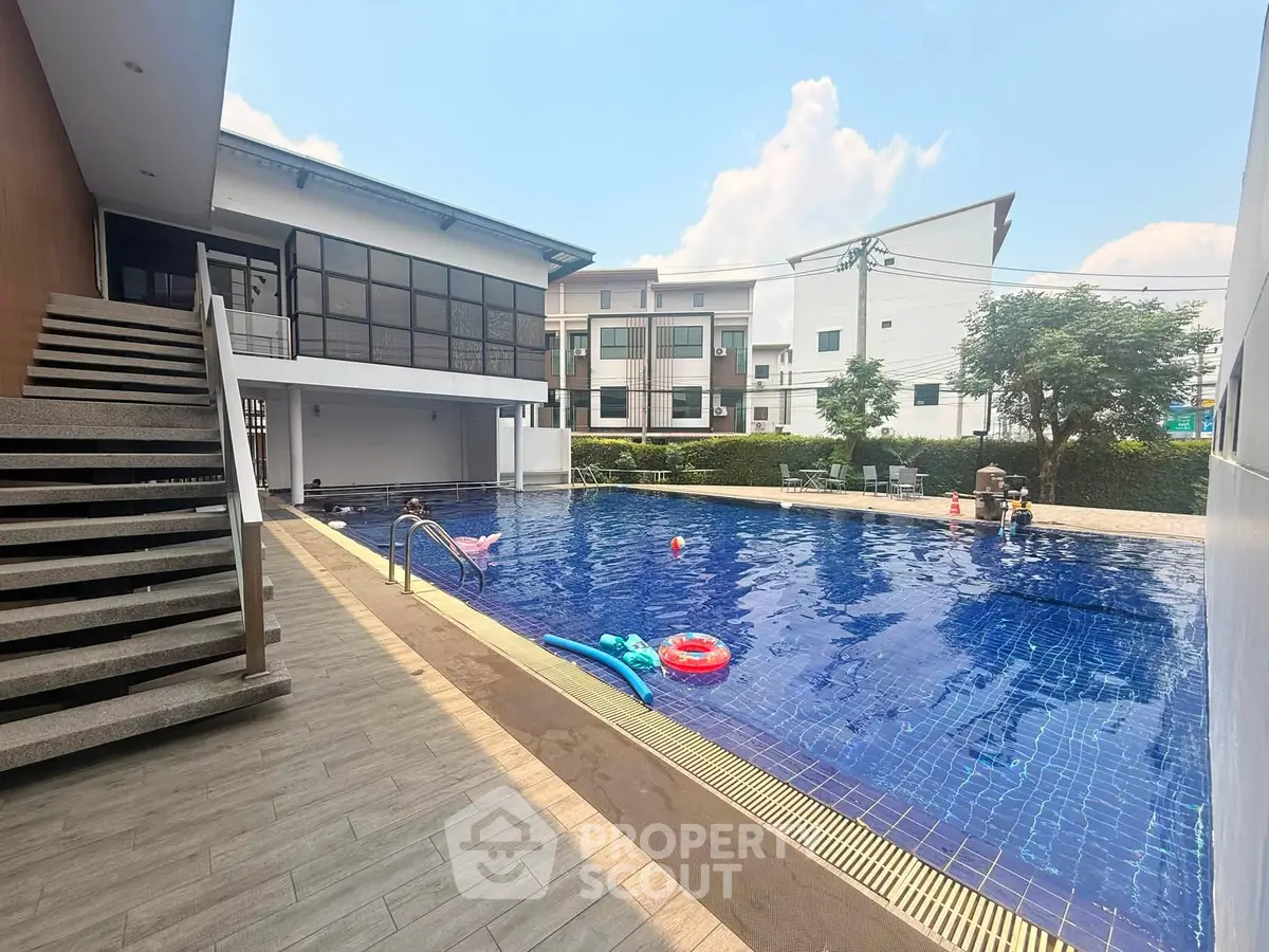 Luxurious residential pool area with modern architecture and inviting blue water.