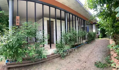 Charming rustic exterior with lush greenery and inviting entrance