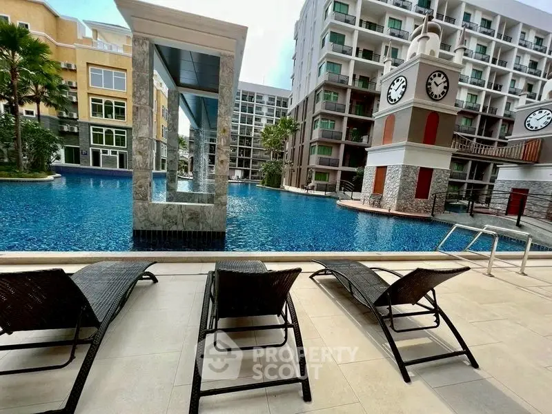 Luxurious poolside view with modern architecture and sun loungers in a high-end residential complex.