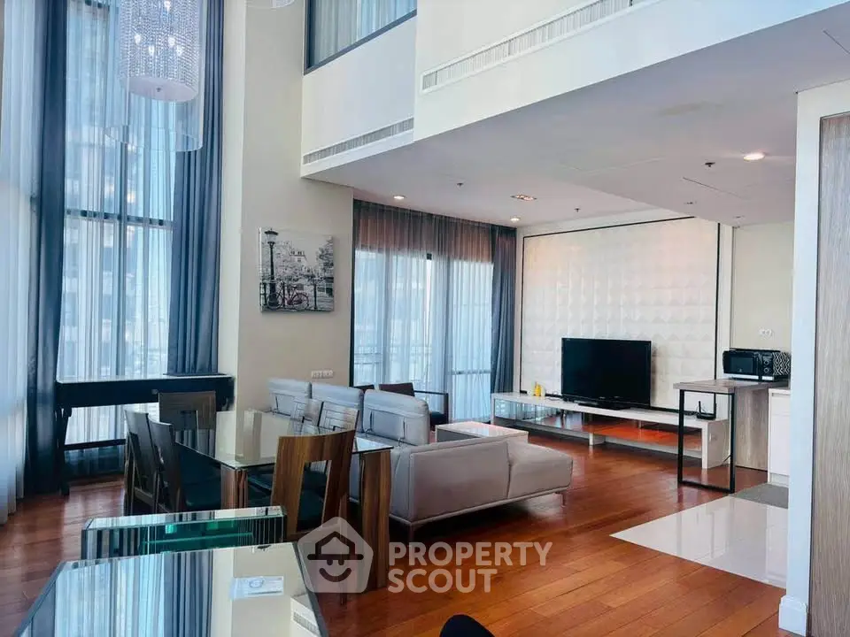 Luxurious modern living room with high ceilings and elegant decor in a spacious apartment.