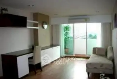 Spacious living room with modern furniture and balcony view