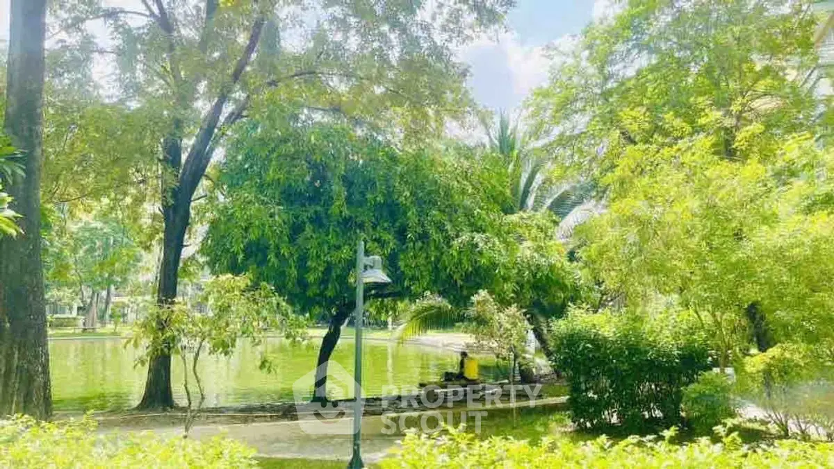 Serene garden view with lush greenery and tranquil pond, perfect for relaxation and outdoor enjoyment.