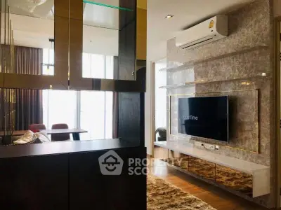 Luxurious modern living room with stylish decor and wall-mounted TV in a high-end apartment.