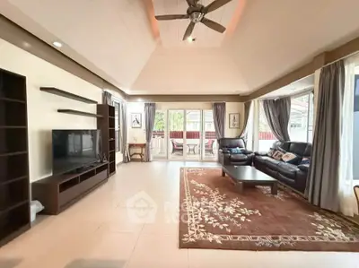 Spacious living room with elegant decor and large windows for natural light