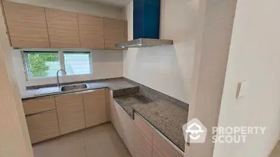 Modern kitchen with sleek cabinetry and granite countertops