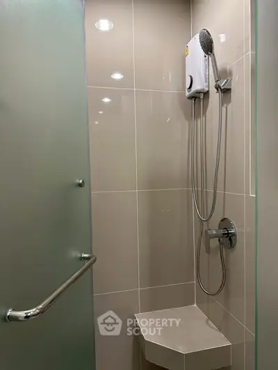 Modern bathroom shower area with sleek design and built-in bench