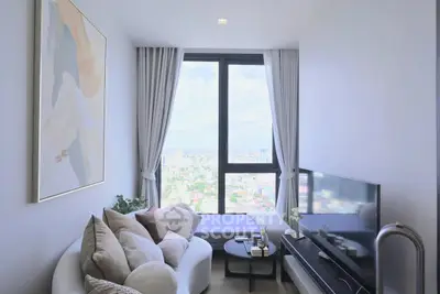 Modern living room with large window offering stunning city view, cozy seating, and elegant decor.