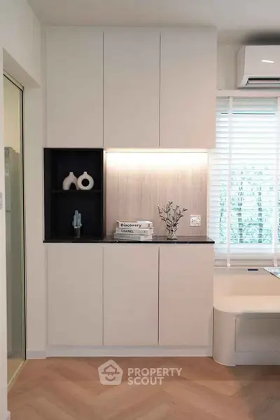 Modern living room with sleek cabinetry and ambient lighting