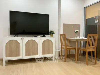 Charming living area with modern TV stand and cozy dining set, perfect for small apartments.