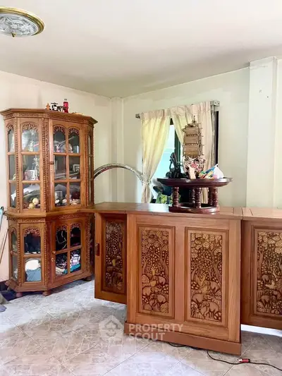Charming living room with elegant wooden furniture and decorative cabinet
