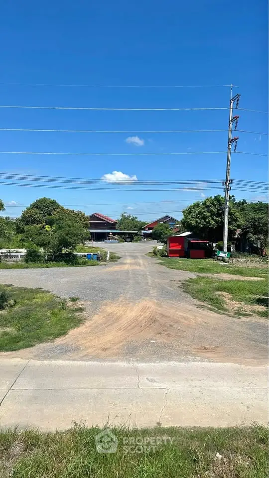 Scenic rural landscape with houses and clear blue sky, ideal for peaceful living.