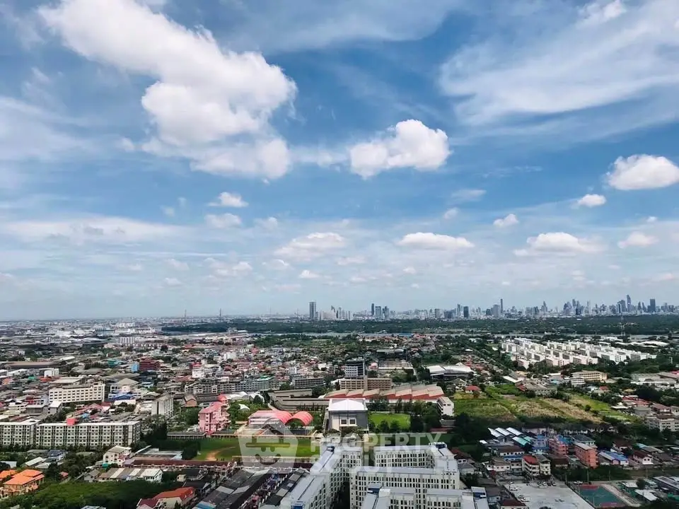Stunning panoramic cityscape view showcasing urban skyline and lush greenery under a vibrant blue sky.