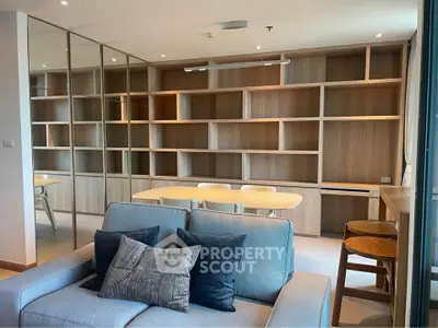 Modern living room with built-in wooden shelves and cozy seating area
