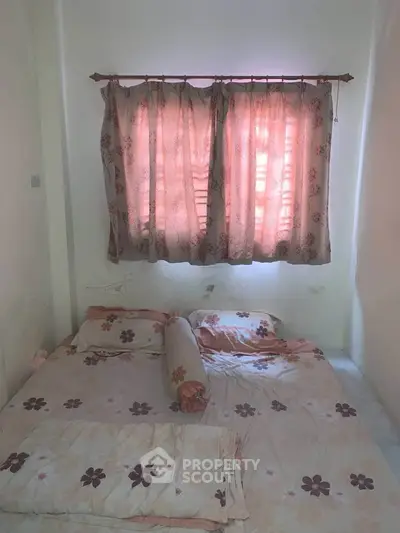 Cozy bedroom with floral curtains and bedding, perfect for a restful retreat.