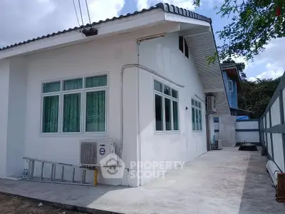 Charming single-story home with modern exterior and large windows, perfect for family living.