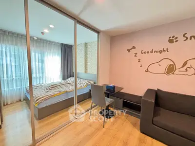 Cozy bedroom with sliding glass doors and playful wall art, perfect for relaxation.