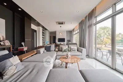 Spacious modern living room with large windows and stylish decor