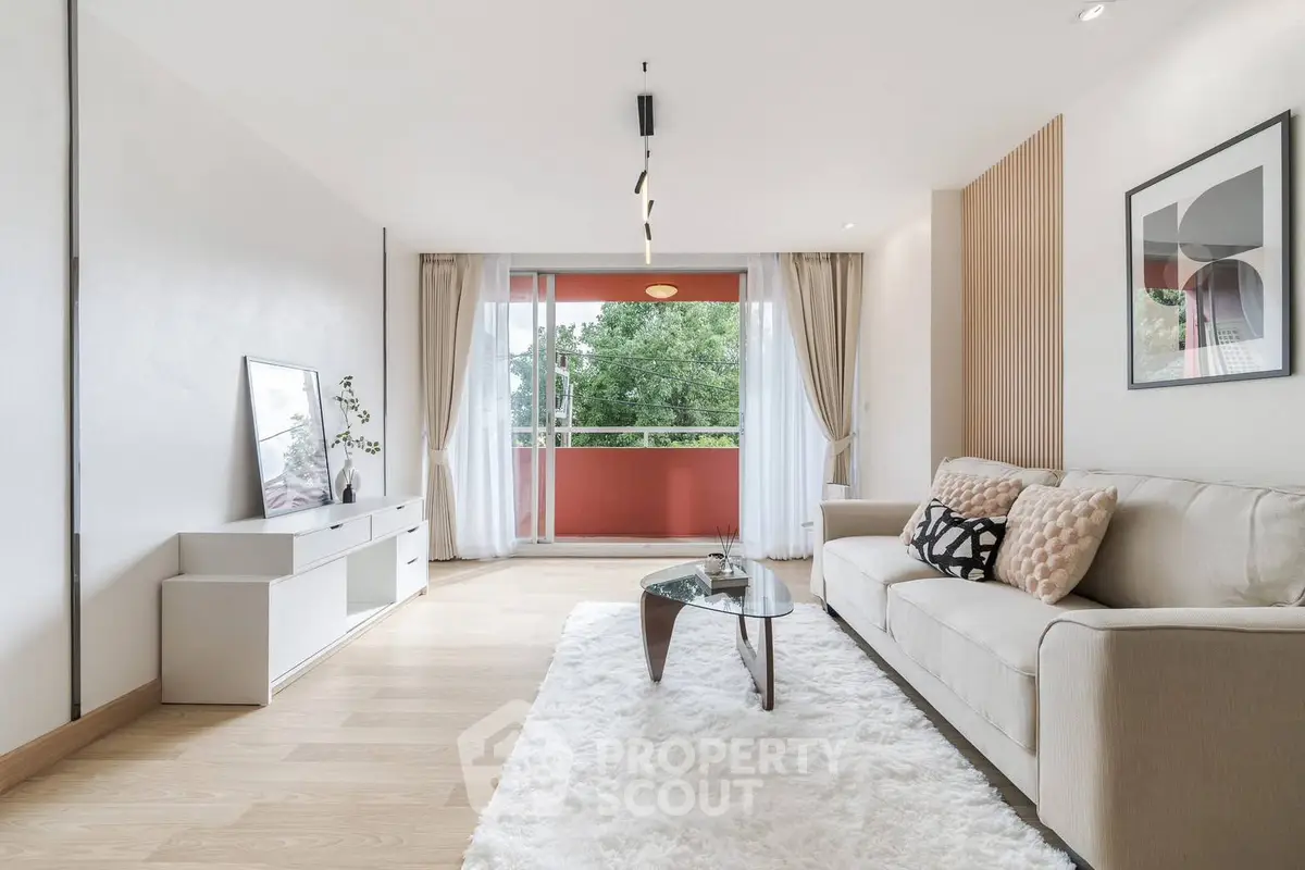 Spacious living room with modern decor and large balcony view