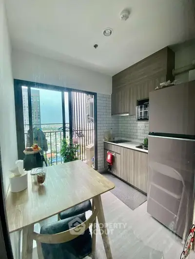 Modern kitchen with open layout and balcony view in urban apartment