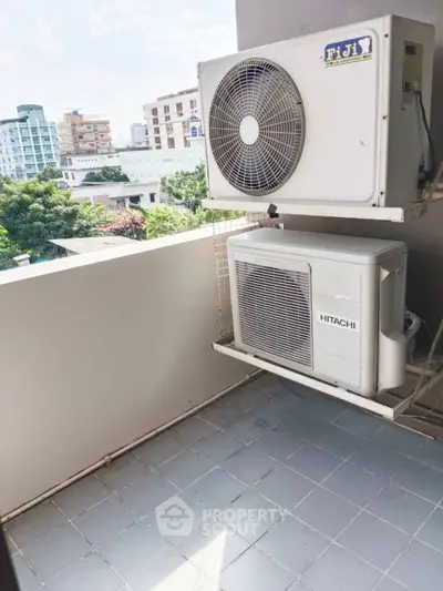 Modern balcony with air conditioning units and city view