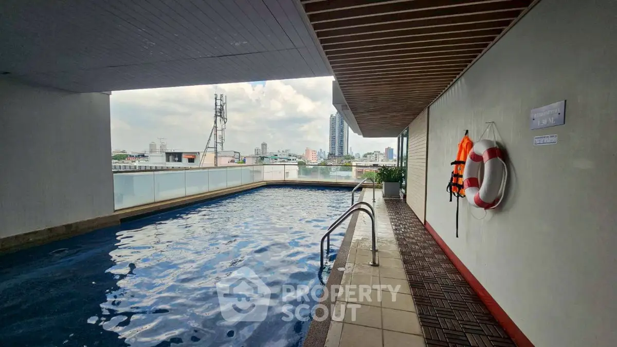 Luxurious rooftop pool with city skyline view, perfect for relaxation and leisure.