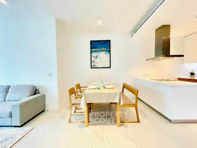 Modern open-plan living and dining area with sleek kitchen design