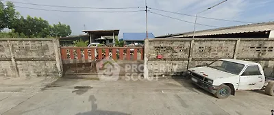 Industrial property with gated entrance and parking area