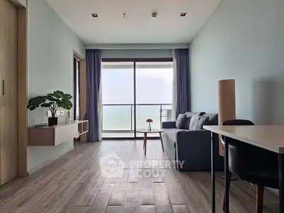 Spacious living room with ocean view, modern decor, and natural light.