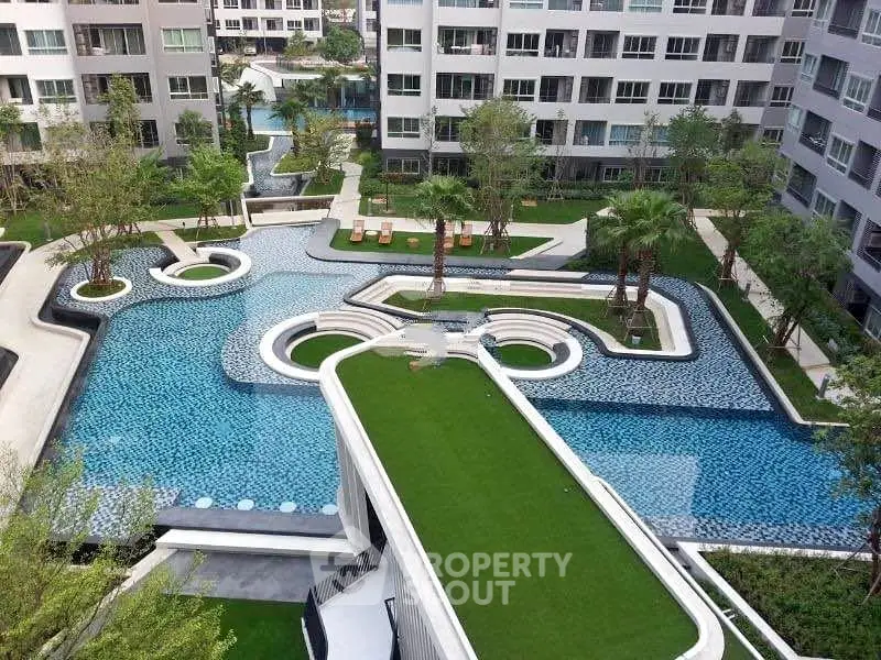 Luxurious residential complex with stunning pool and lush greenery, offering a serene urban oasis.