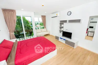 Spacious modern bedroom with balcony and garden view, featuring stylish furniture and natural light.