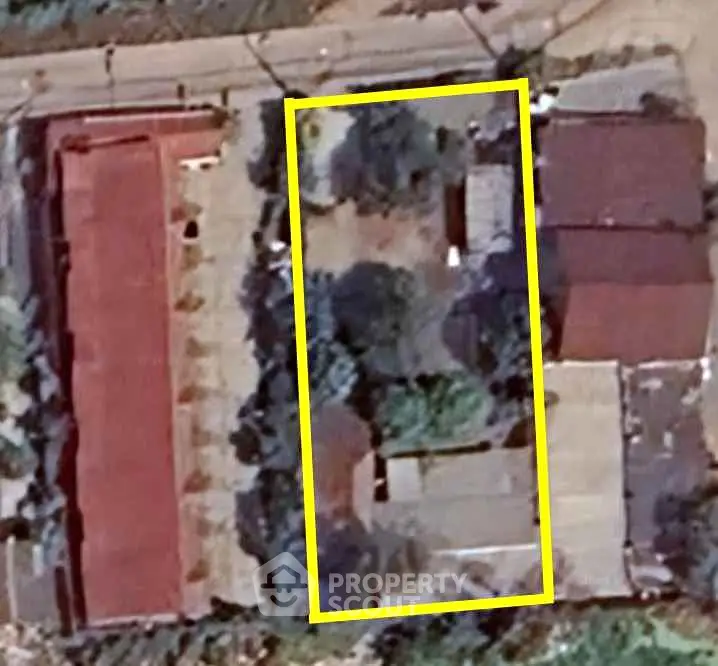 Aerial view of residential property with outlined boundary, showcasing potential for development.