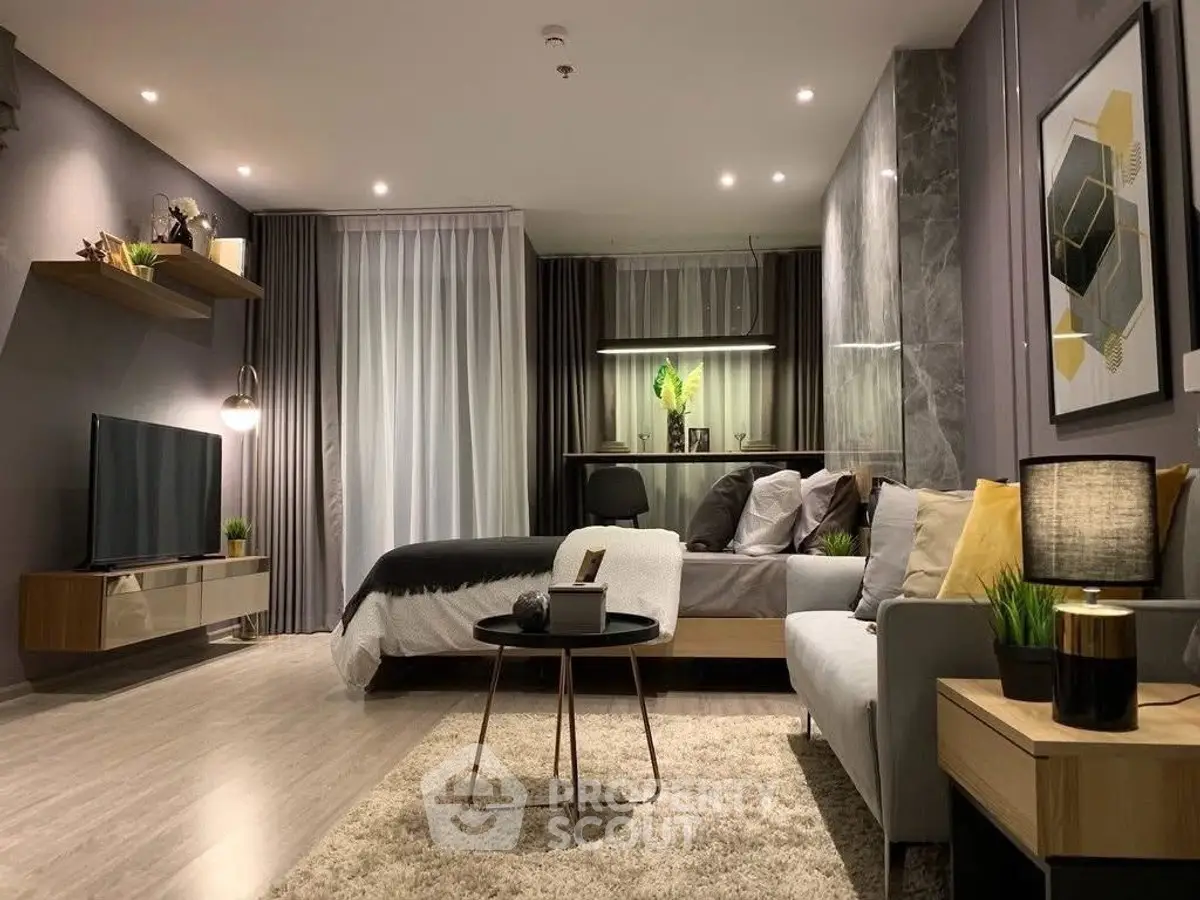 Modern studio apartment with stylish decor, featuring a cozy living area and elegant bedroom setup.
