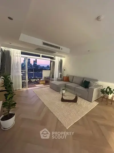 Spacious living room with city view and large balcony, perfect for modern urban living.