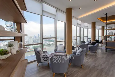Luxurious high-rise living room with panoramic city views and elegant furnishings.