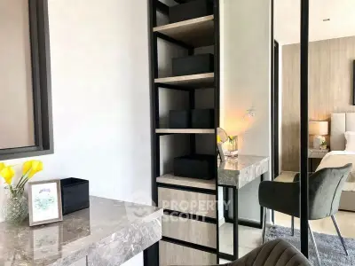 Modern bedroom with stylish decor and elegant furniture, featuring a marble desk and cozy chair.