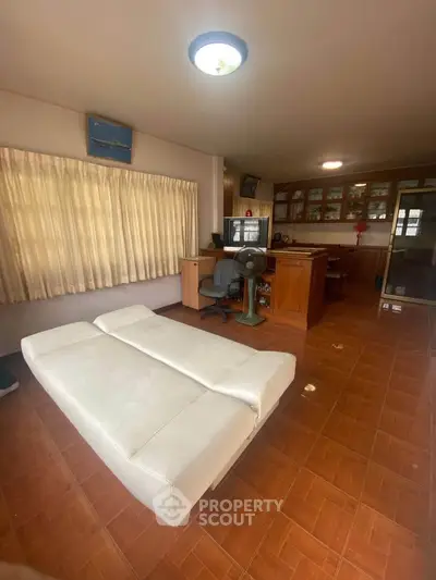 Spacious living room with modern furniture and ample natural light.