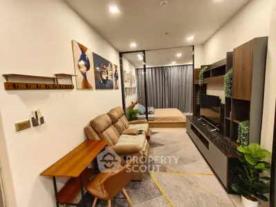 Modern living room with cozy seating and stylish decor leading to a bedroom