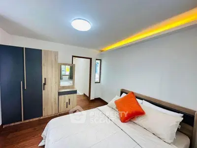 Modern bedroom with stylish decor and cozy ambiance, featuring a comfortable bed and sleek wardrobe.