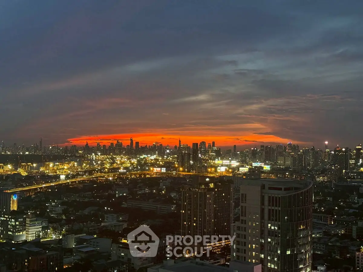 Stunning city skyline view at sunset with vibrant orange hues.
