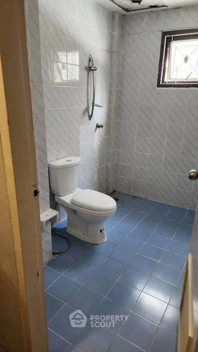 Simple bathroom with blue tiled floor and white fixtures
