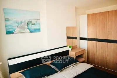 Modern bedroom with stylish wooden furniture and serene wall art