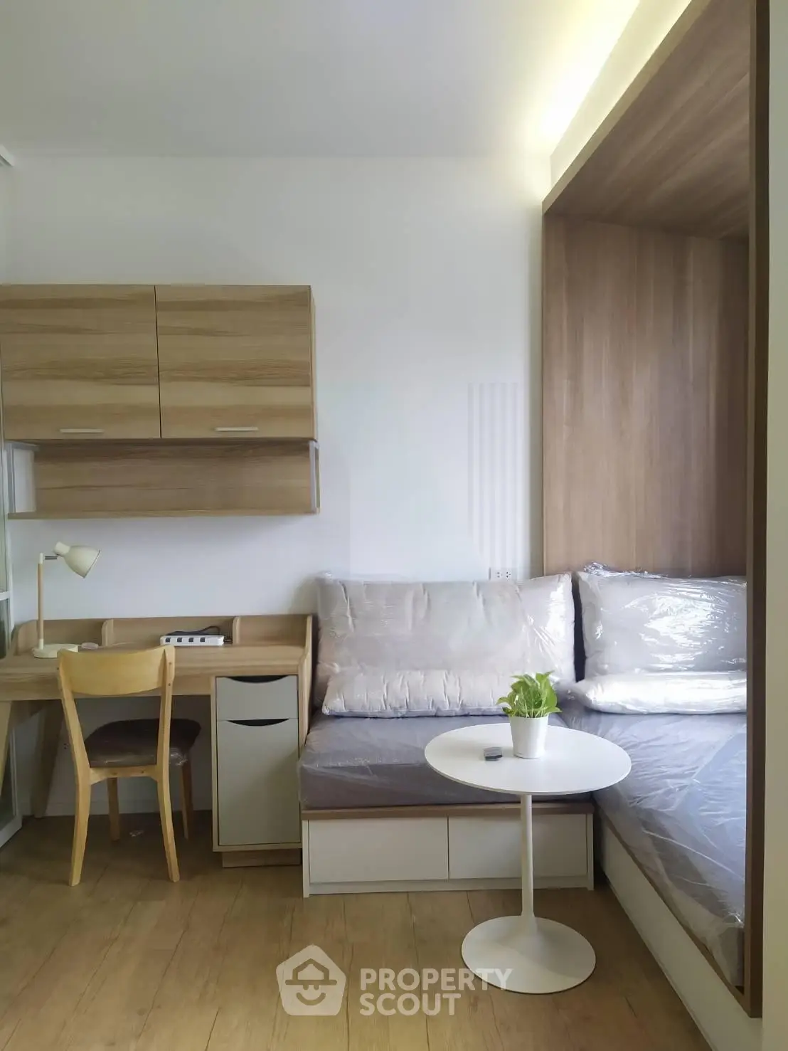 Cozy modern living room with built-in seating and workspace, perfect for compact urban living.