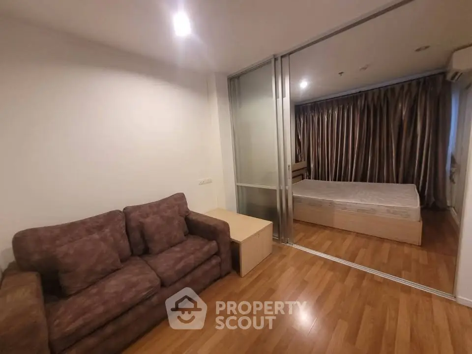 Modern apartment with cozy living area and sliding glass doors to bedroom
