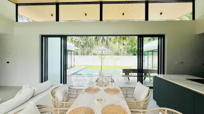 Luxurious open-plan living room with pool view and stylish decor