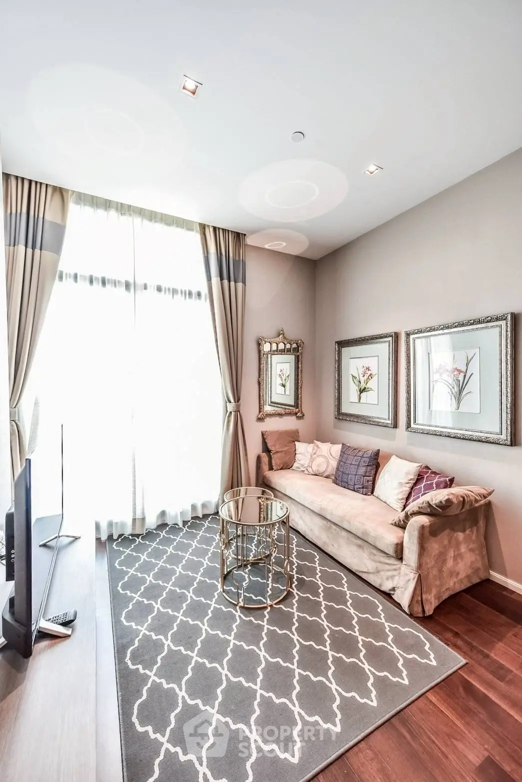 Elegant living room with plush sofa, stylish decor, and large window for natural light.