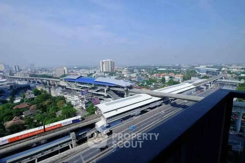 Stunning cityscape view from a high-rise balcony overlooking urban transit and skyline.